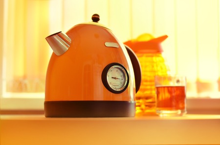 orange teapot with termometer on kitchen  tableの写真素材