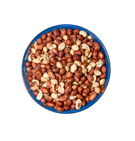 Peeled peanuts for background. Roasted peanut beans with skins. Isolated in a blue plate on a white background.の写真素材