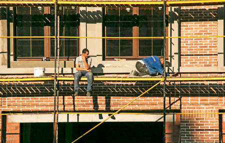 Dnepropetrovsk, Ukraine - 10.30.2021: High-rise finishing works. An employee repairs the facade of a...