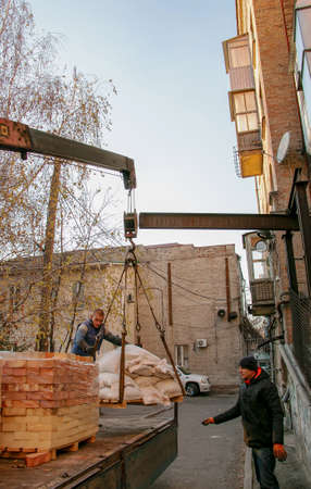 Dnepropetrovsk, Ukraine - 11.24.2021: Loading sandbags for the renovation of an apartment in a...