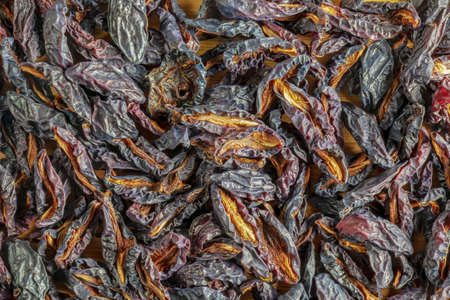 Background of dried black plum slices. Chips from dried fruits. Health food. top view.の写真素材