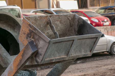 Mobile concrete mixer at the construction site. Close-up of gravel being loaded into a concrete making machine.の写真素材
