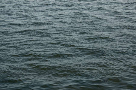 Abstract background of river water flow under the influence of light. The texture of the water.の写真素材