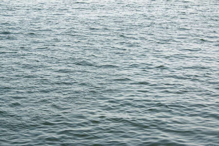 Abstract background of river water flow under the influence of light. The texture of the water.の写真素材