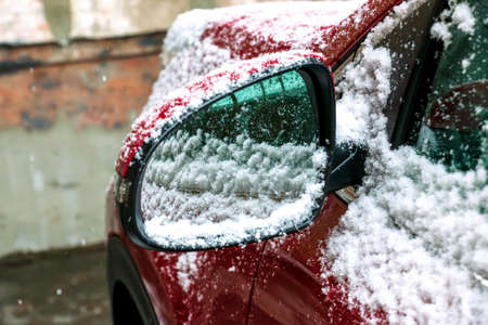 Car mirror in the snow. winter concept. Part of the car.の写真素材