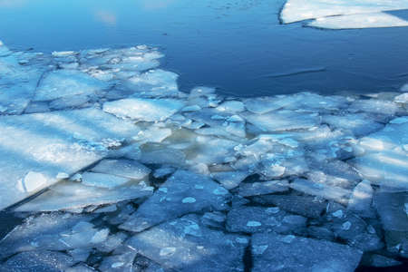 Winter nature background with blocks of ice on frozen water in spring. Abstract background of drifting ice on water.の写真素材