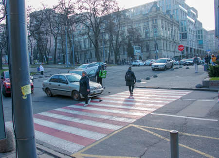 Dnepropetrovsk, Ukraine - 11.22.2021: Accident of two passenger cars due to wrong actions of a food delivery man on a moped.のeditorial素材