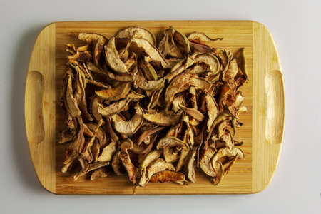 background from dried pears. Dried fruits. texture. Heap of dried pears in slices on a wooden background. Chips from dried fruits. Health food.の写真素材