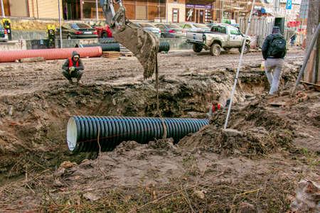 Dnipropetrovsk, Ukraine - 11.30.2021: Construction work on laying sewer pipes in urban areas....