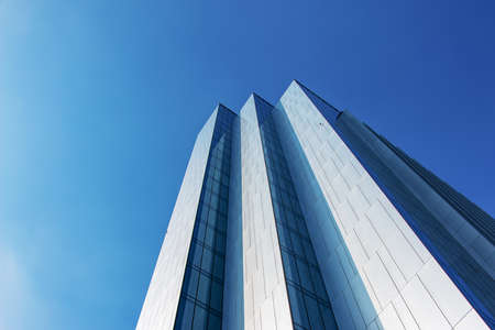 Looking Up Blue Modern Office Building. Building made of glass and metal.の写真素材