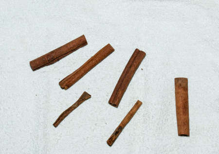 Cinnamon sticks for making tea mixture. Cinnamon sticks on a white cloth. Healthy food concept.の写真素材