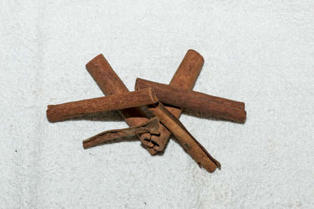 Cinnamon sticks for making tea mixture. Cinnamon sticks on a white cloth. Healthy food concept.の写真素材