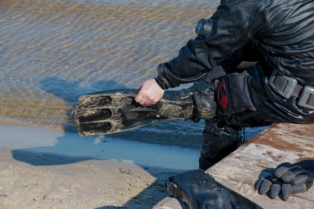 Professional diver near the river coastline. commercial diving. Winter.の写真素材