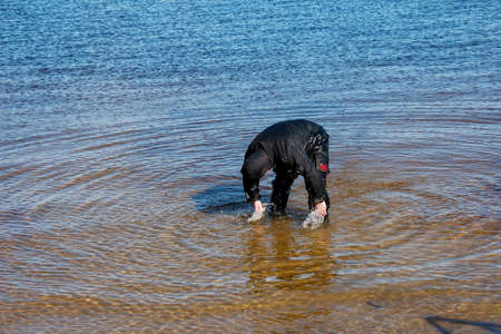 Professional diver near the river coastline. commercial diving. Winter.の写真素材
