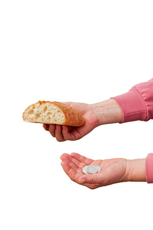 Last money for bread. Bread in the hand of a middle-aged woman. The concept of the world food crisis associated with the war in Ukraine. isolated on white background.の写真素材