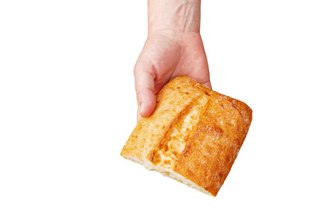 Bread in the hand of a middle-aged woman. The concept of the world food crisis associated with the war in Ukraine. isolated on white background.の写真素材