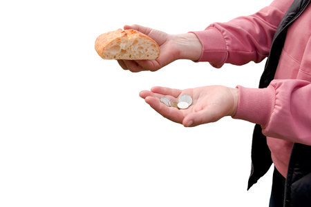 Last money for bread. Bread in the hand of a middle-aged woman. The concept of the world food crisis associated with the war in Ukraine. isolated on white background.の写真素材