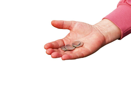 Last money for groceries. Coins in the hand of a middle-aged woman. The concept of the world food crisis associated with the war in Ukraine. isolated on white background.の写真素材