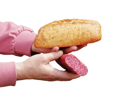 Bread and sausage in the hand of a middle-aged woman. The concept of the world food crisis associated with the war in Ukraine. isolated on white background.の写真素材