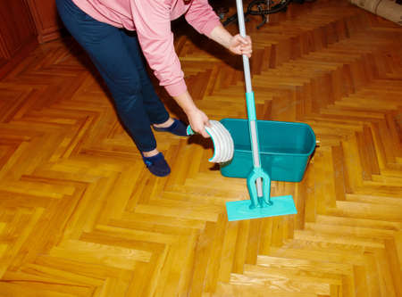 Mop your wood floor. A woman prepares a mop. housekeeping concept.の写真素材