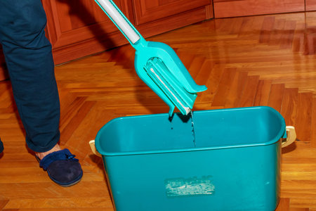 Mop your wood floor. A woman prepares a mop. housekeeping concept.の写真素材