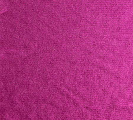 Lilac-pink knitted carpet close-up. Textile texture on a lilac-pink background. Detailed warm yarn background. Natural wool fabric, sweater fragment.の写真素材