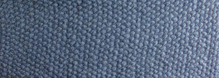 Blue-gray knitted carpet close-up. Textile texture on a gray-blue background. Detailed warm yarn background. Natural wool fabric, sweater fragment.の写真素材