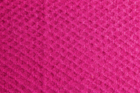Lilac-pink knitted carpet close-up. Textile texture on a lilac-pink background. Detailed warm yarn background. Natural wool fabric, sweater fragment.の写真素材