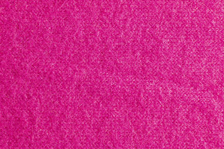 Lilac-pink knitted carpet close-up. Textile texture on a lilac-pink background. Detailed warm yarn background. Natural wool fabric, sweater fragment.の写真素材