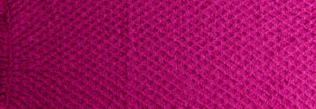 Lilac-pink knitted carpet close-up. Textile texture on a lilac-pink background. Detailed warm yarn background. Natural wool fabric, sweater fragment.の写真素材
