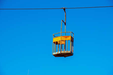 Old cable car in Dnepropetrovsk. Cable car cabins against the background of the blue sky and the urban landscape.の写真素材