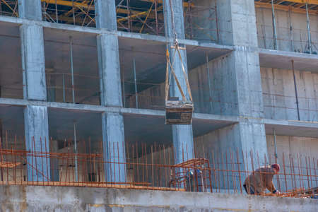 Dnepropetrovsk, Ukraine - 02.23.2022: A worker prepares formwork for a modern metal-concrete structure of a residential building.の写真素材