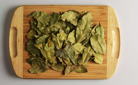 Spice Aromatic dry bay leaf. Aromatic spice for food. Background of dry bay leaf on a wooden kitchen...