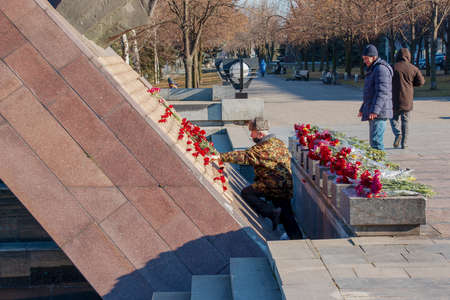 Dnipro, Ukraine - 15.02.2022: Monument to veterans of the Afghan war 1979-1989. Red carnations on...