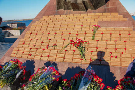 Dnipro, Ukraine - 02.15.2022: Monument to veterans of the Afghan war 1979 - 1989 Red carnations on the granite slab of the monument.のeditorial素材