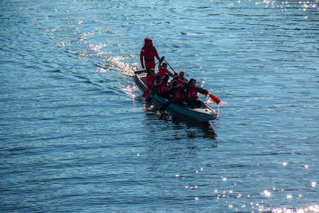 Dnipro, Ukraine - 02.13.2022: Men's rowing team on the blue water. winter training.
