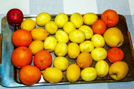 fresh citrus background. On the table are lemons, peeled lemons, orange oranges and a red apple.の写真素材