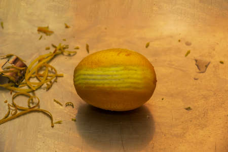 The process of preparing an alcoholic drink Limoncello at home. Lemon with partially peeled zest.の写真素材