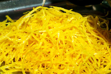 The process of preparing an alcoholic drink Limoncello at home. Freshly peeled lemon peel prepared for tincture.の写真素材