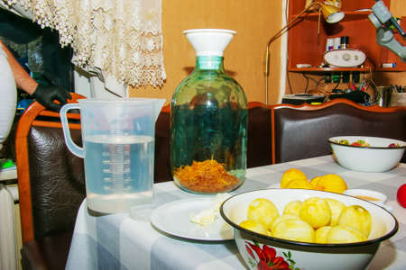The process of preparing an alcoholic drink orancello at home. A jar of orange peel is prepared for pouring alcohol.の写真素材