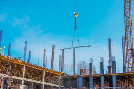 Dnepropetrovsk, Ukraine - 02.09.2022: A worker prepares formwork for a modern metal-concrete structure of a residential building.のeditorial素材
