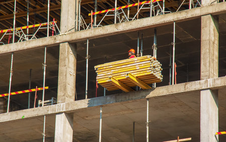 Dnepropetrovsk, Ukraine - 02.09.2022: A worker prepares formwork for a modern metal-concrete structure of a residential building.のeditorial素材