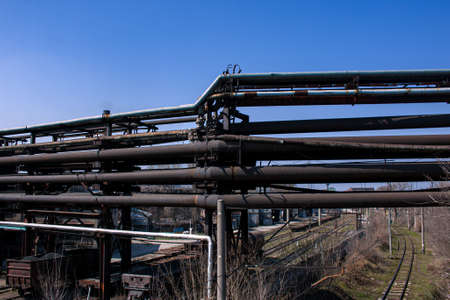 Gas pipelines at a metallurgical plant against the blue sky. Concept of economic crisis. Ecology concept.の写真素材