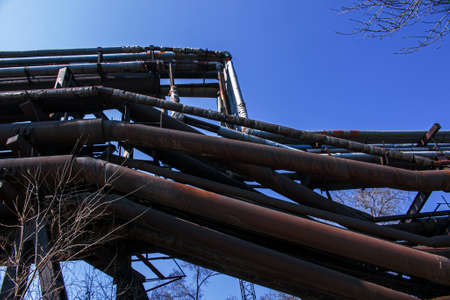 Gas pipelines at a metallurgical plant against the blue sky. Concept of economic crisis. Ecology...