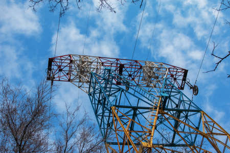 High voltage electric power lines on pylons in blue sky.の写真素材
