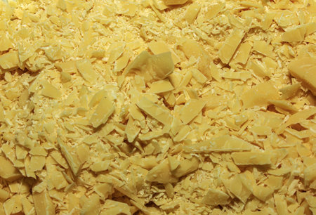 Cocoa butter background, top view, texture. Cocoa butter is one of the ingredients in making chocolate at home. Close-up of crushed cocoa butter, top view.の写真素材