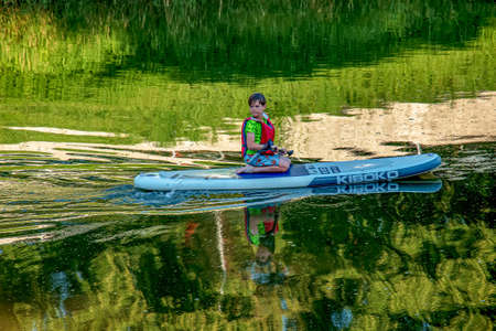 Nitra, Slovakia - 06.15.2022: A teenage boy is sailing in a canoe on the Nitra river.のeditorial素材