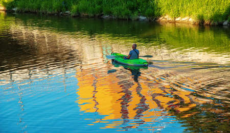 Nitra, Slovakia - 06.15.2022: A middle-aged man is sailing in a canoe on the Nitra river.のeditorial素材