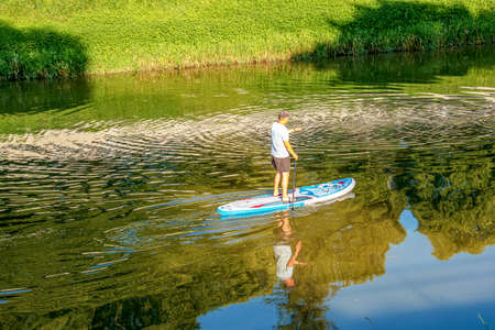 Nitra, Slovakia - 06.15.2022: A young man is sailing in a canoe on the Nitra river.のeditorial素材