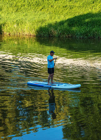 Nitra, Slovakia - 06.15.2022: A young man is sailing in a canoe on the Nitra river.のeditorial素材